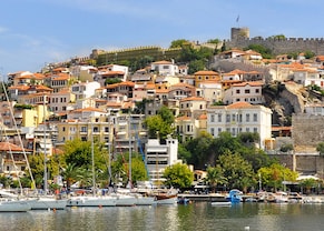 buildings with orange roofs are located on a mountainside of kavala