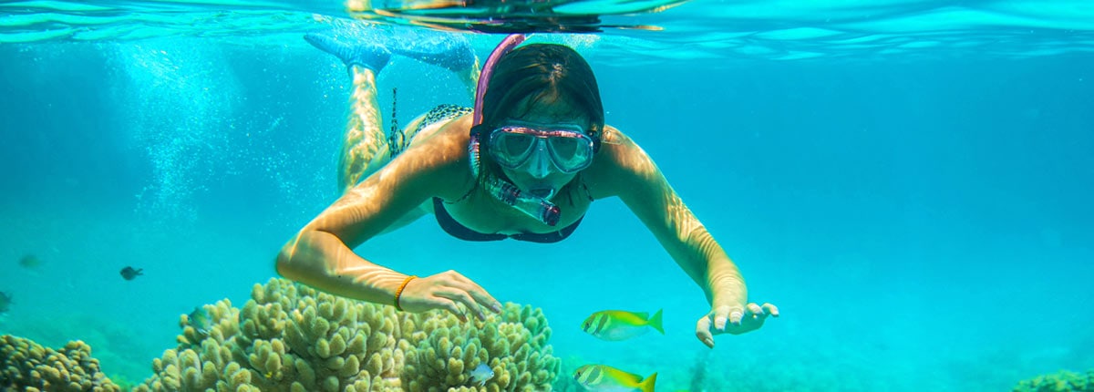 girl snorkeling in the waters of mexico