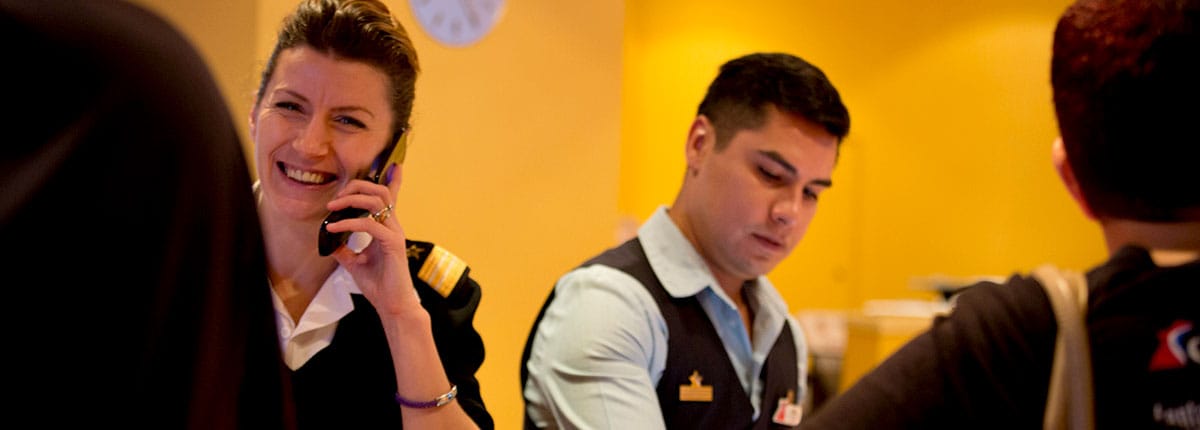 two carnival employees helping guests