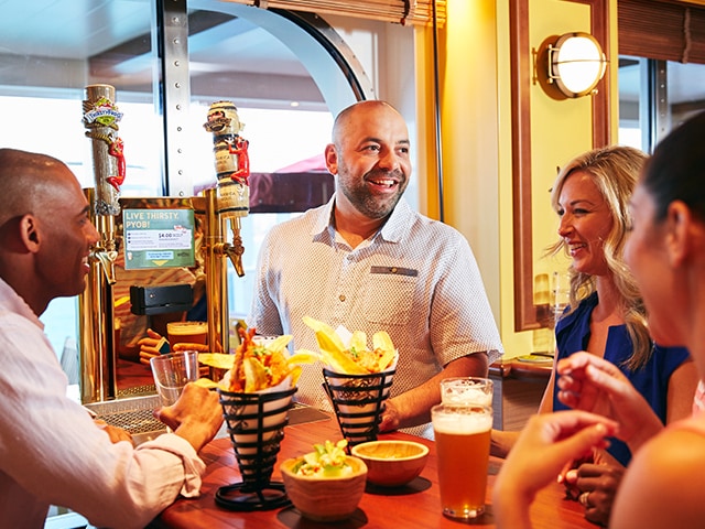 friends enjoying beers and food at the redfrog pub