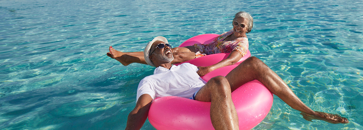 couple floating on beach floats