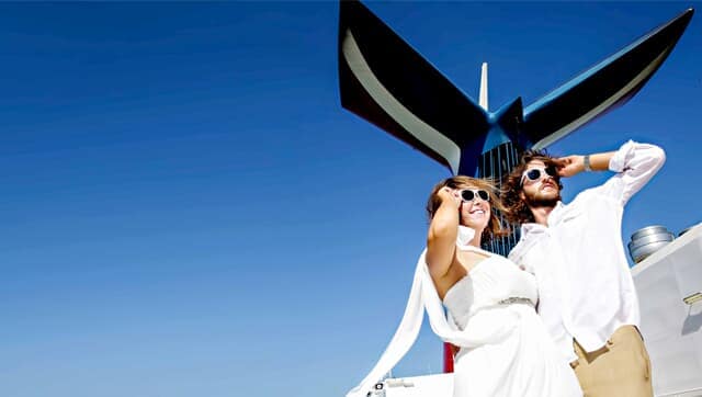 a couple posing for a photo after their wedding with the carnival funnel in the back