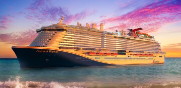 Carnival Tropicale sailing in tropical waters at sunset
