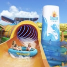 family sliding down a raft waterslide aboard carnival tropicale