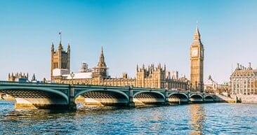 big ben and house of parliament sitting across from the london bridge