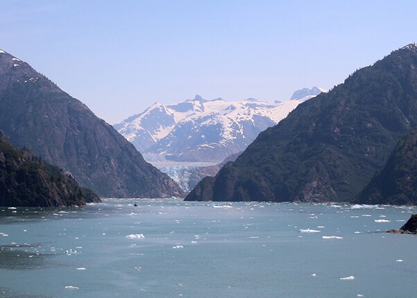 large body of water surrounded by tall mountains 