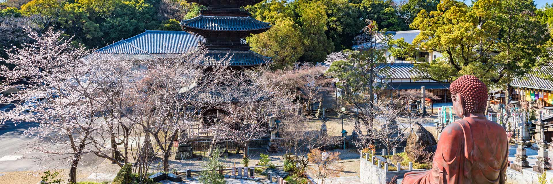a statue is located in front of a temple