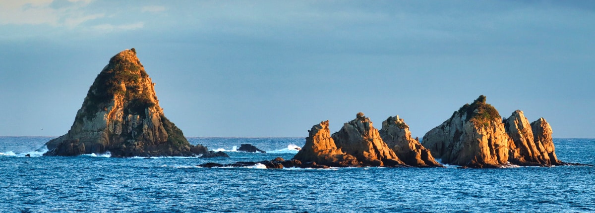 large rock formations in the ocean in miyazaki japan