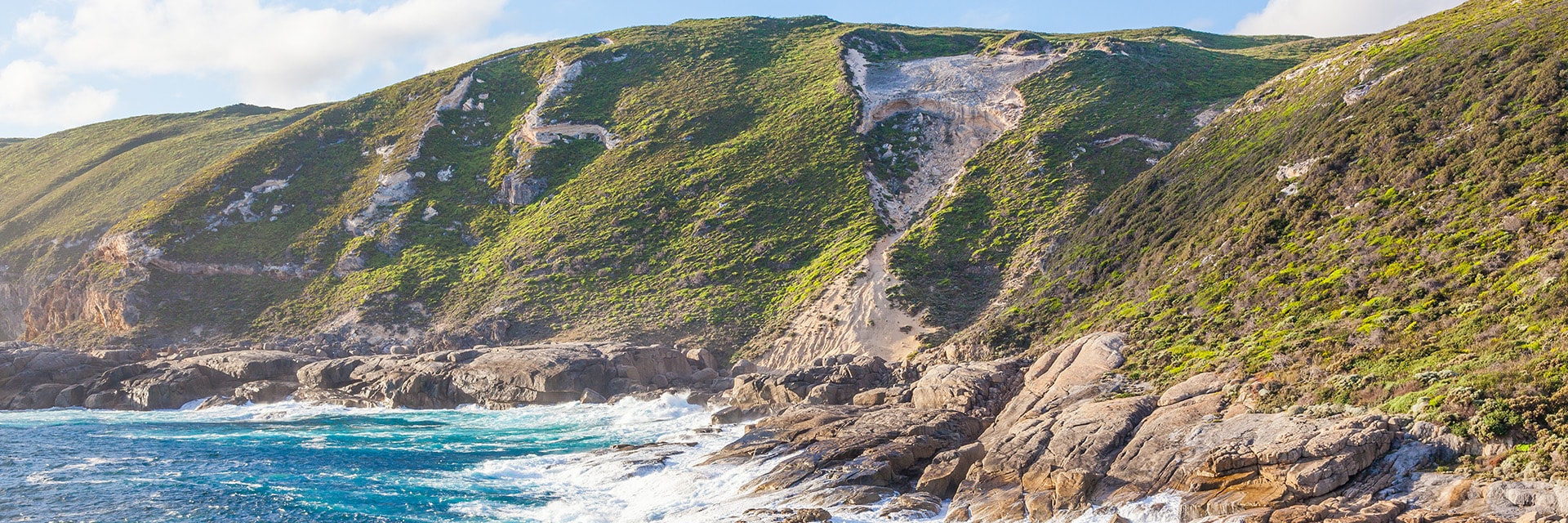 the ocean brushes against a mountain located in albany