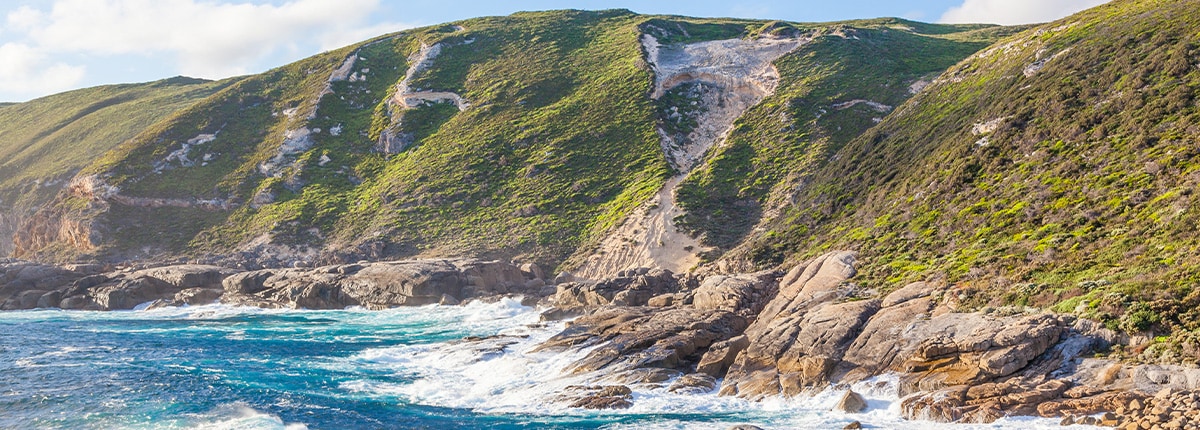 the ocean brushes against a mountain located in albany