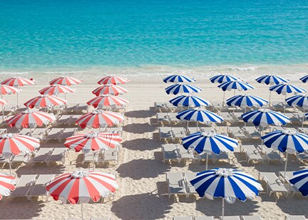 red and blue umbrellas at a beach at relaxaway half moon cay