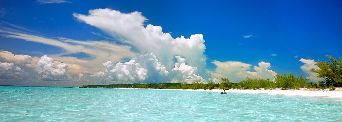 clear blue waters and white sand on half moon cay's beach