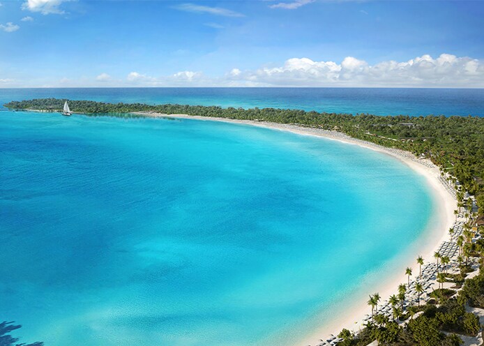 aerial of half moon cay's crescent-shaped beach and its turquoise waters