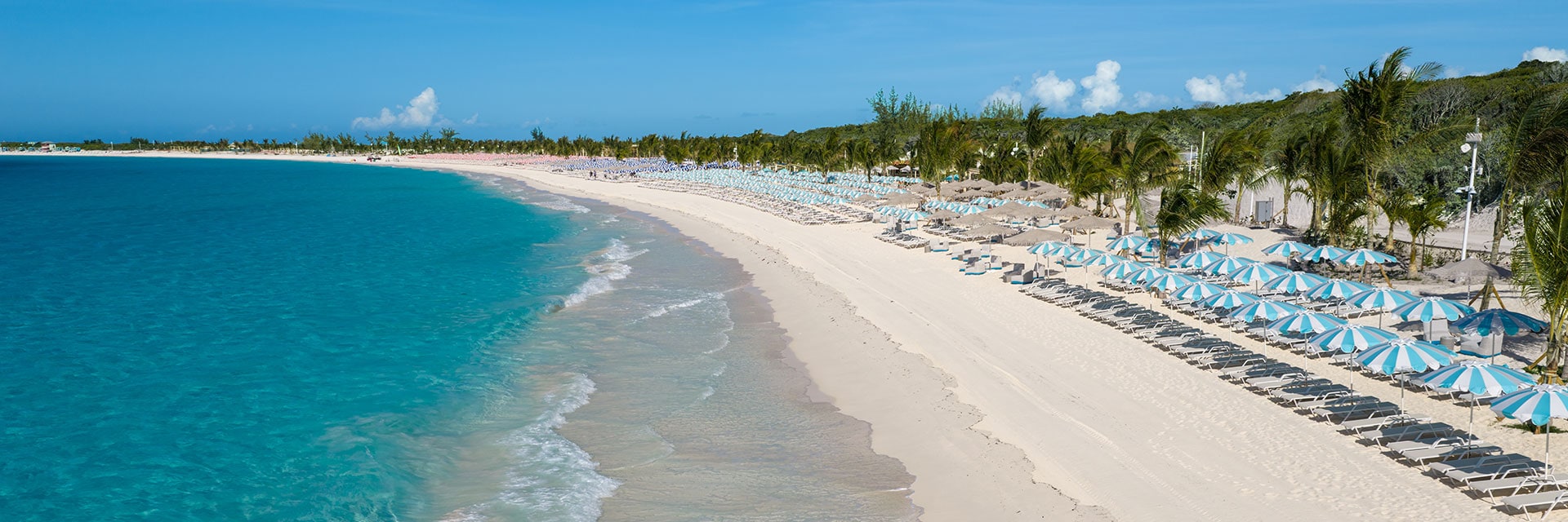 beach at relaxaway, half moon cay with chairs and umbrellas