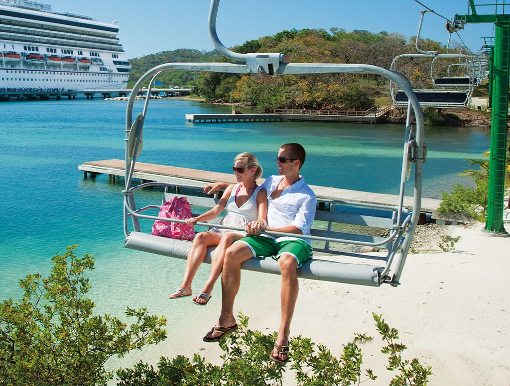 a couple relaxes in a aerial chairlift