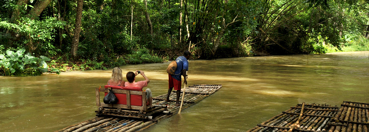 couple taking raft ride through the jamaican forest