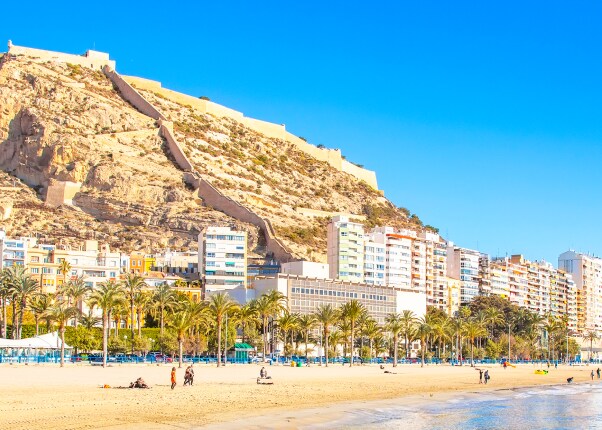 large mountain looming over a coastal beach 