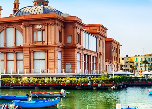 view of several blue kayaks and the beautiful margherita theatre 
