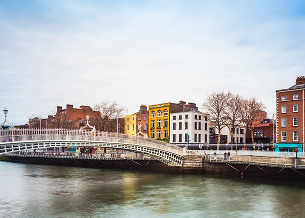 view of the ha'penny bridge and colorful buildings in dublin, ireland
