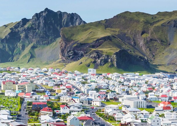 numerous homes surrounded by mountains