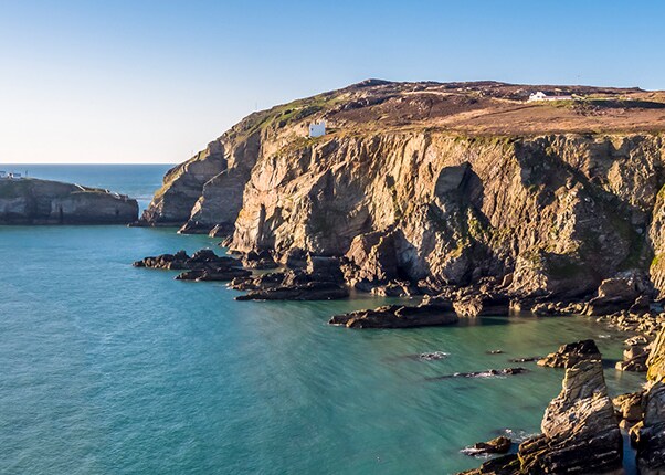 cliffside view of the ocean and the stack lighthouse