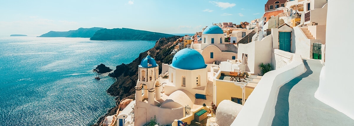 white buildings along the teal coastline of santorini, greece