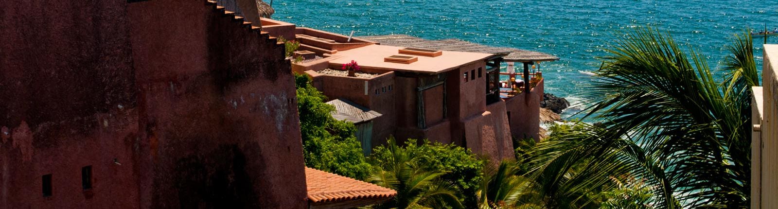 Close up shot of the side of a beautiful clay color home in Zihuanatejo, Mexico.