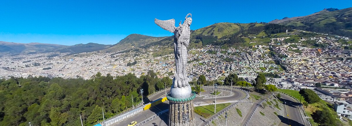 the panecillo monument and city view in the background in quito