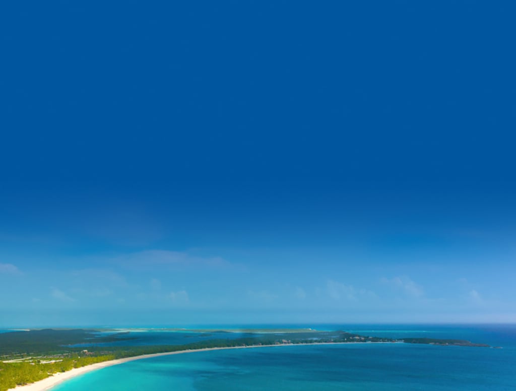 view of the sea brushing on the white sandy beach