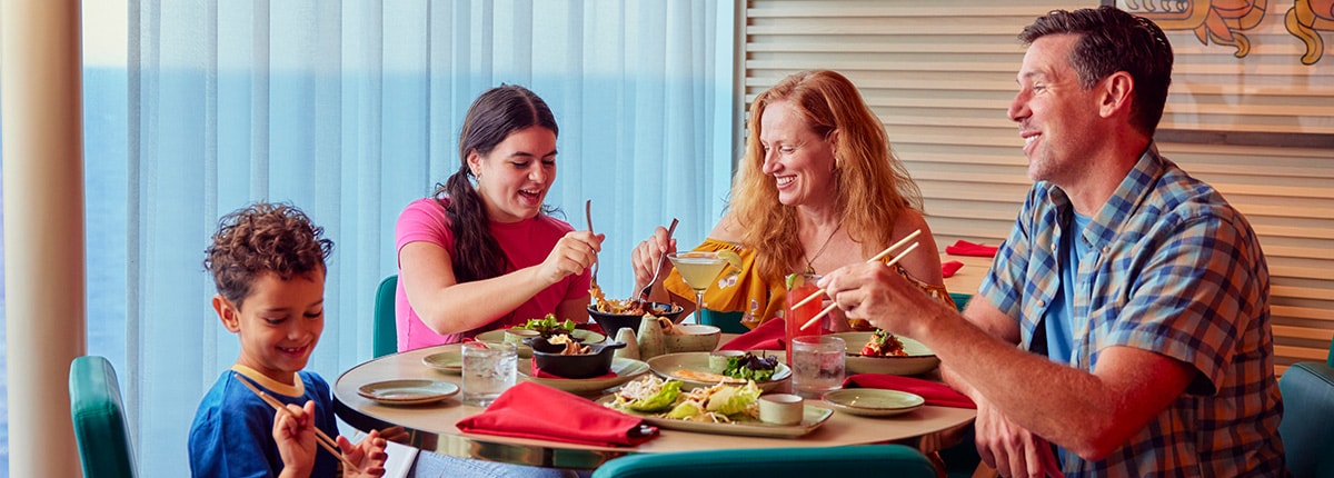 a family of four sits at a table to enjoy a meal at chibang