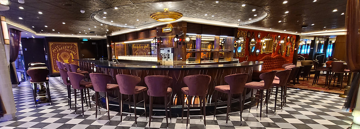 a set of velvet bar stools surrounds an elegant bar located in fortune teller