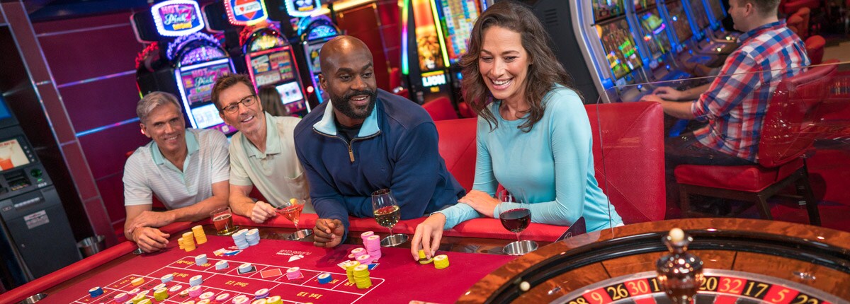 people playing table games on carnival cruise line