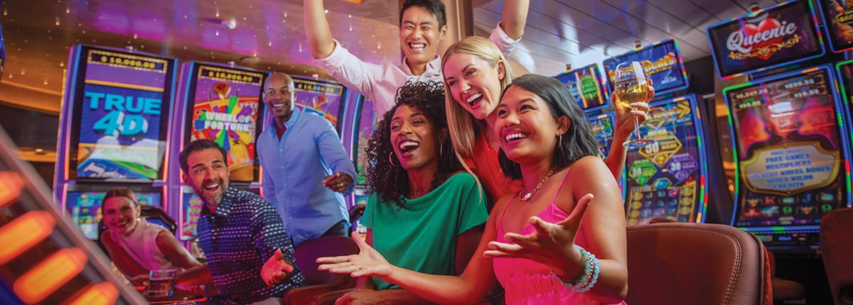 a group of friends cheer with joy at the slot machines