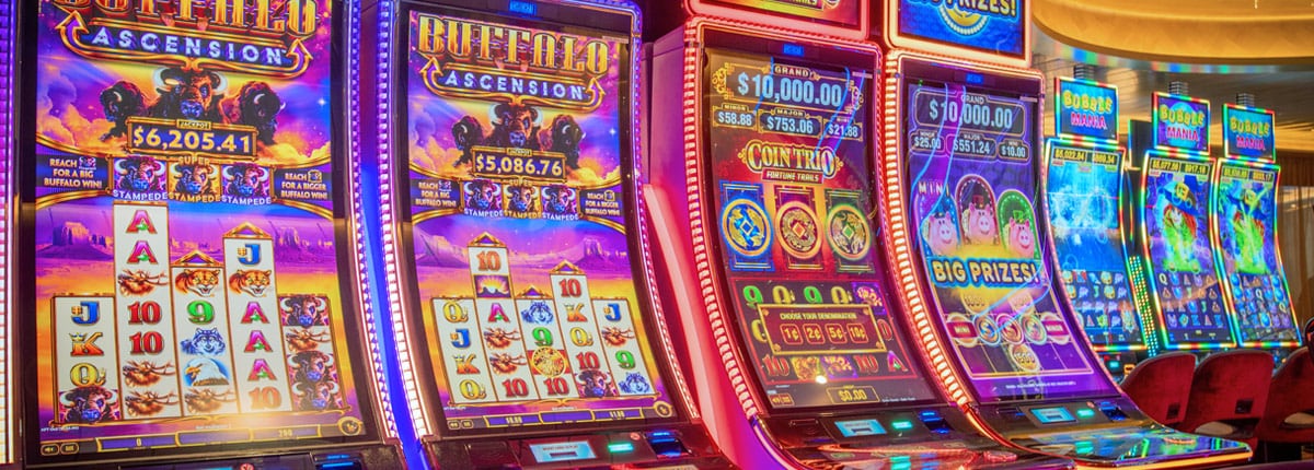 colorful slot machines are lined up in a row