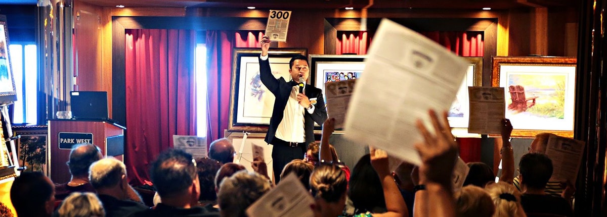 an art auction on a carnival ship with guests bidding 