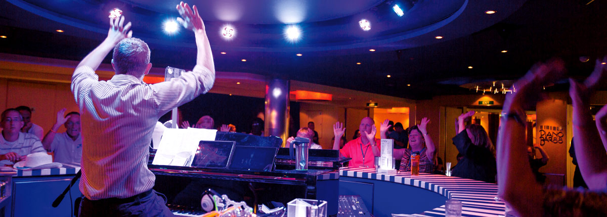 order your favorite cocktail and sing along at piano bar on carnival cruise line