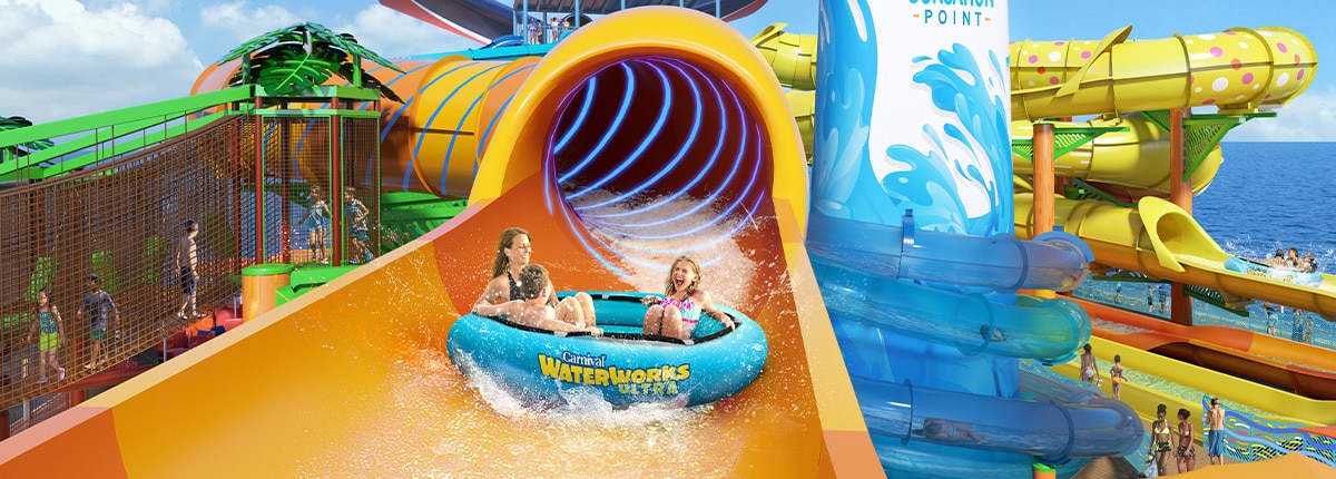 three guests slides down a waterlisde in a large blue floating raft onboard carnival festivale