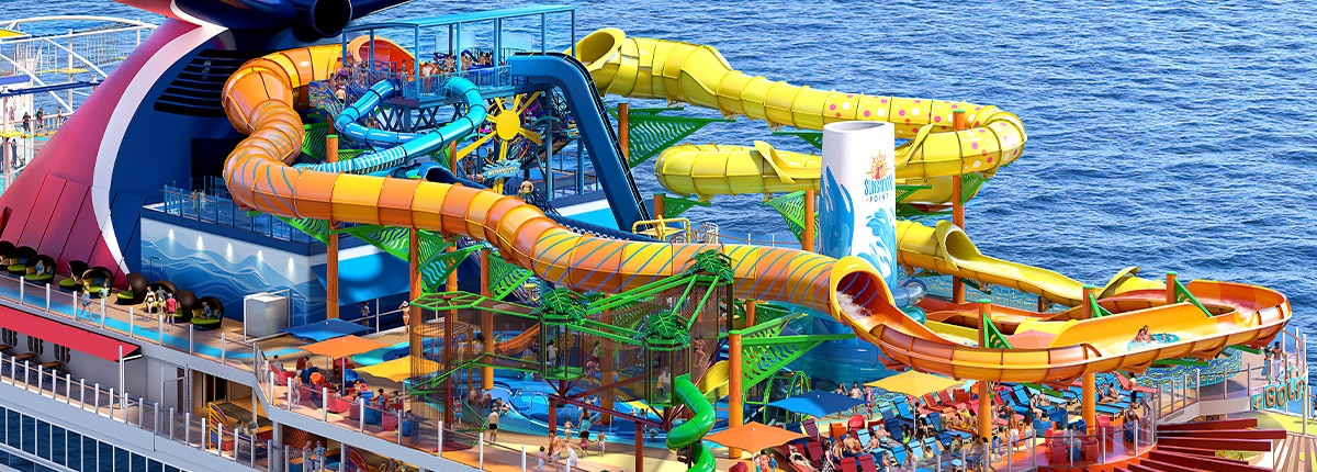 an orange blue and yellow waterslide are located on deck onboard carnival festivale