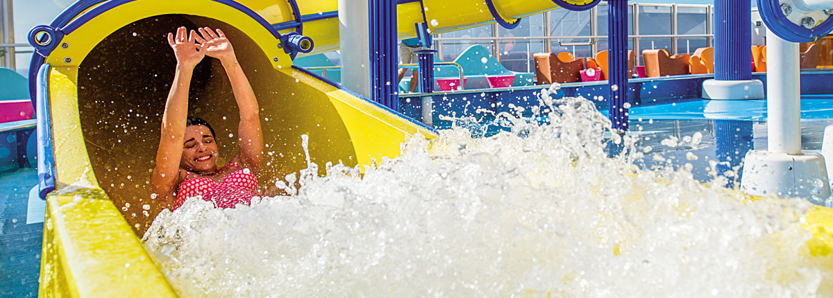 a woman splashing at the end of the twister waterslide