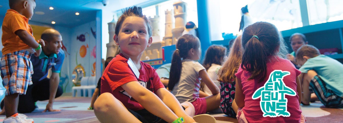 kids gathered together at camp ocean, camp ocean penguins logo
