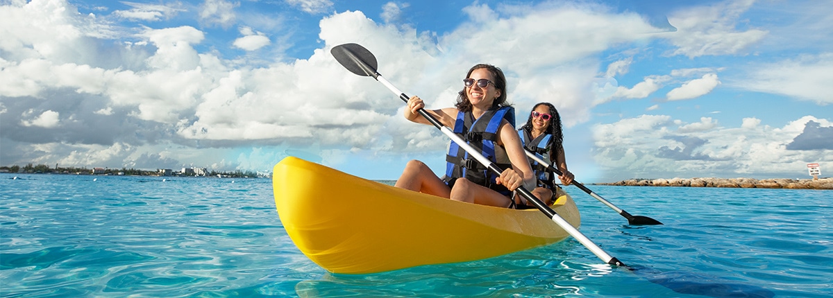 two ladies kayaking through beautiful clear blue waters