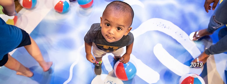 a young child lookiing up at the camera in 2019