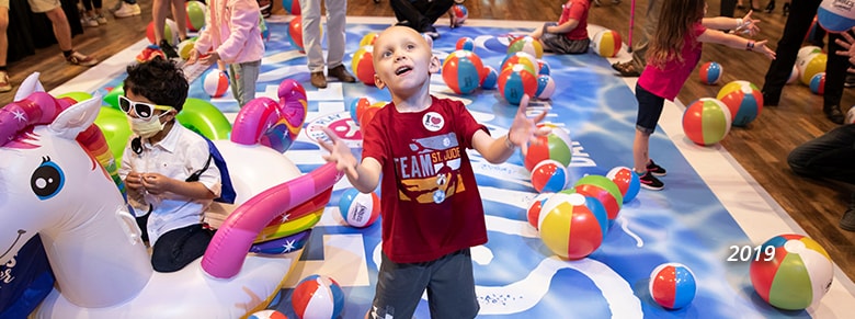 a child playing with the colorful beach balls in 2019
