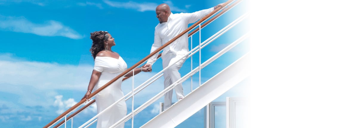 a married couple holds hands while walking up the stairs