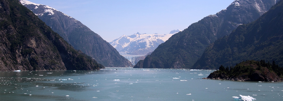 large body of water surrounded by tall mountains 