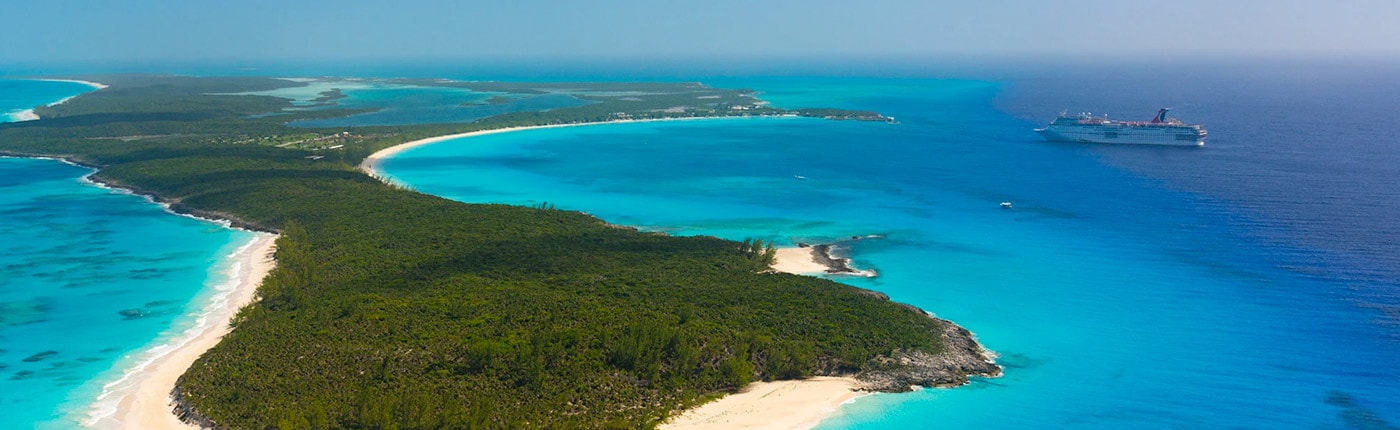 aerial view of half moon cay with carnival ship nearby
