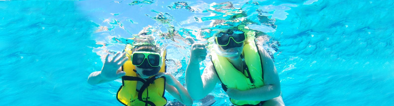 Two people snorkeling in the clear blue waters of Grand Turk