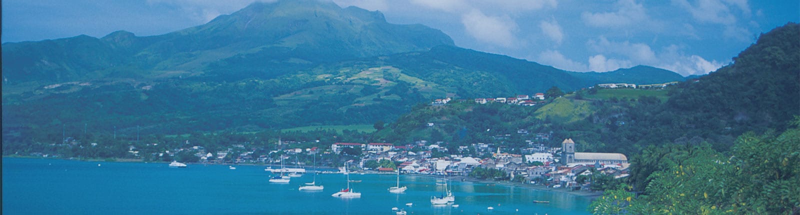 Beautiful coastline view of Martinique with boats, homes and mountains