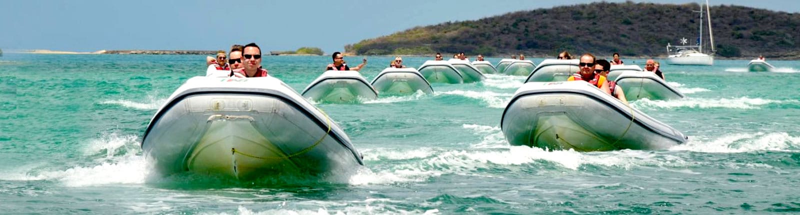 Motorboats cruising in formation in blue waters off St. Maarten