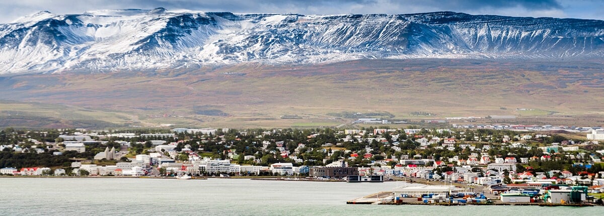 view of akureyri city in iceland with mountains in the background 